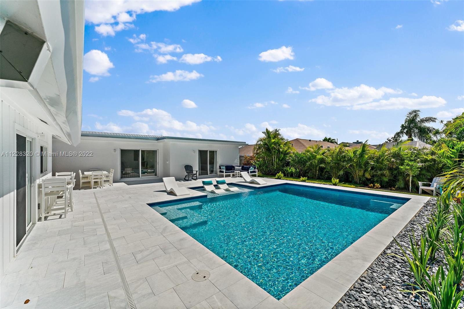 19 Shay Place Tequesta, FL 33469 - Photo 46 of 46 a view of a patio with swimming pool table and chairs