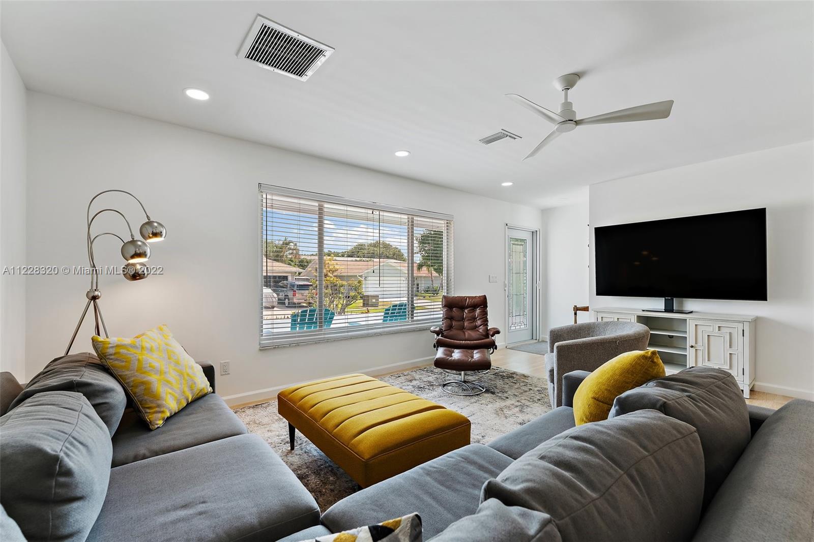 19 Shay Place Tequesta, FL 33469 - Photo 9 of 46 a living room with furniture and a flat screen tv
