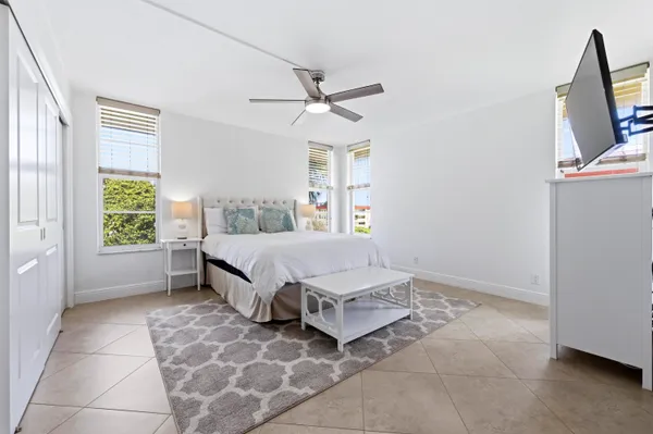 a spacious bedroom with a bed and a window