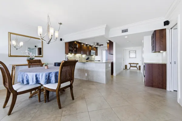 a living room with furniture a dining table and kitchen view