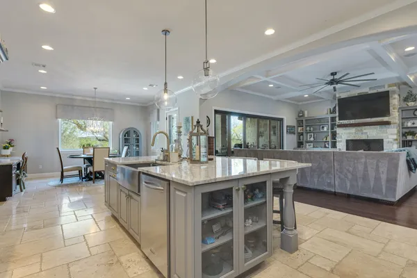 a large kitchen with stainless steel appliances a sink and cabinets