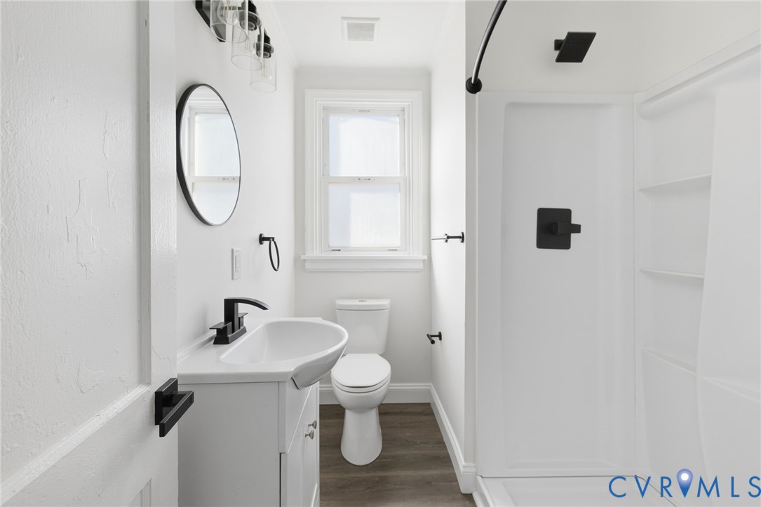 5009 Regent Road Richmond, VA 23230 - Photo 17 of 22 Full bathroom with a shower stall, vanity, and dar