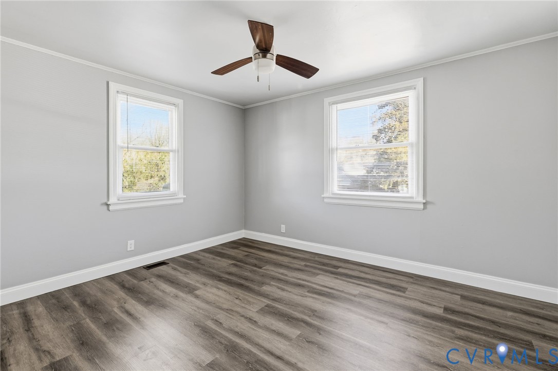 5009 Regent Road Richmond, VA 23230 - Photo 19 of 22 Spare room featuring crown molding, dark wood-styl