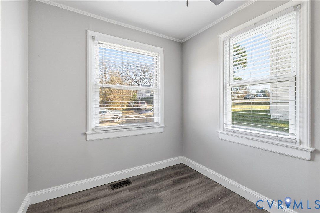 5009 Regent Road Richmond, VA 23230 - Photo 7 of 22 Spare room with crown molding, dark wood-type floo