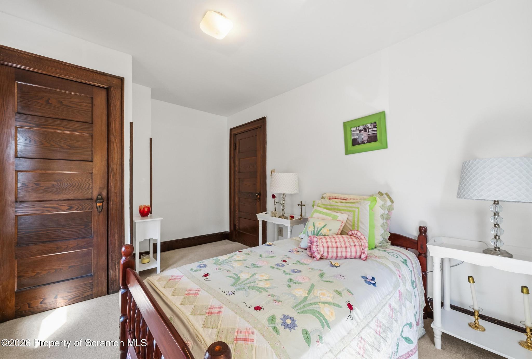 616 Myrtle Street Scranton, PA 18510 - Photo 29 of 65 a bedroom with a bed and a lamp on the dresser