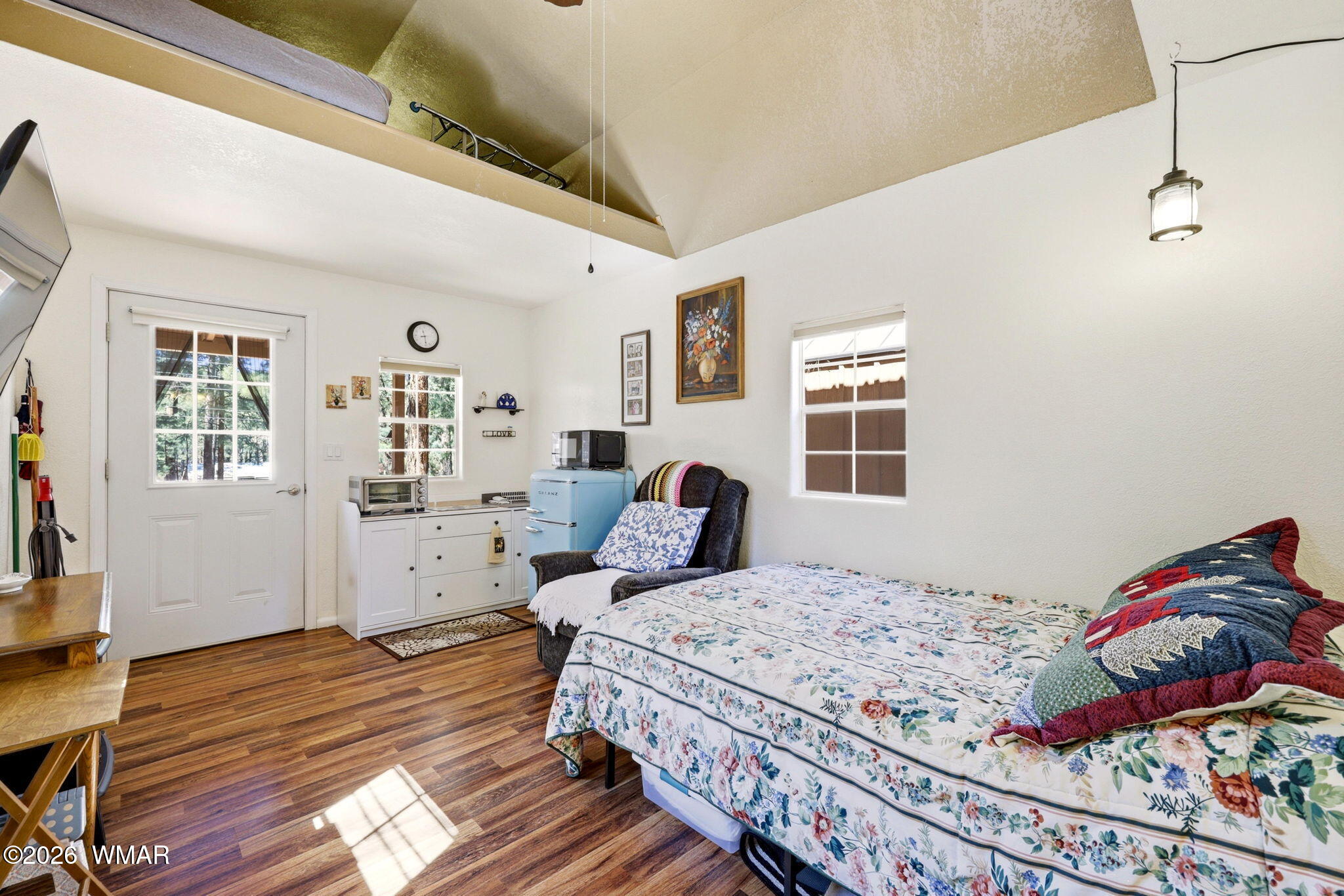 2893 Tracy Road Overgaard, AZ 85933 - Photo 20 of 26 a bedroom with a bed and wooden floor