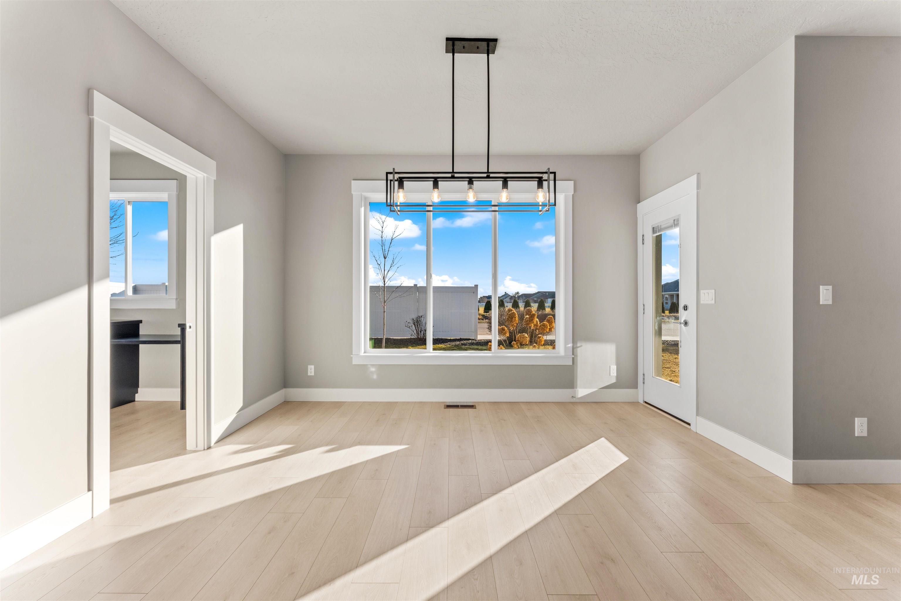 8081 Tandy Cove Street Middleton, ID 83644 - Photo 10 of 41 Unfurnished dining area featuring light wood finished floors and baseboards
