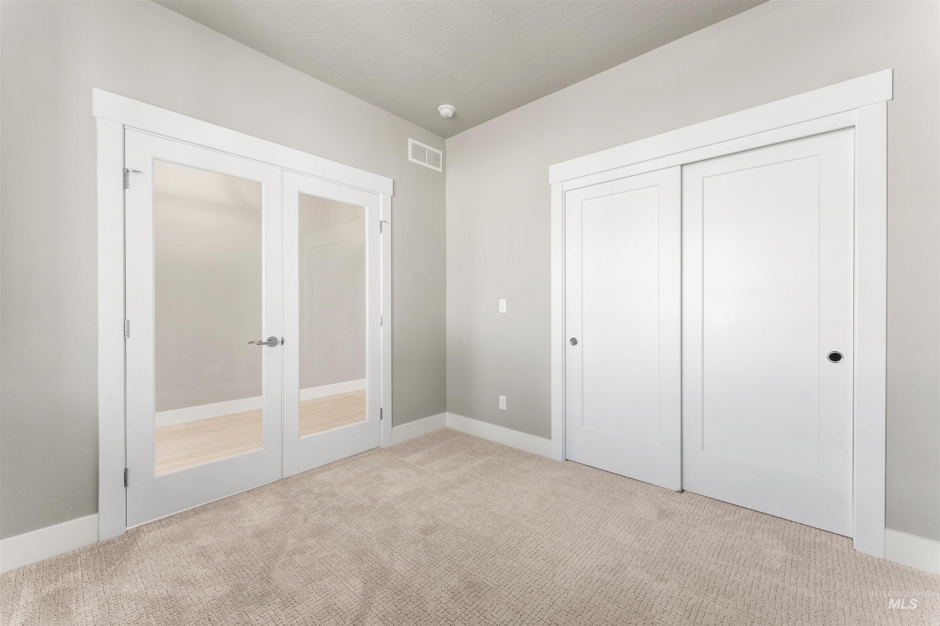 8081 Tandy Cove Street Middleton, ID 83644 - Photo 15 of 41 Unfurnished bedroom featuring french doors, carpet floors, and a closet