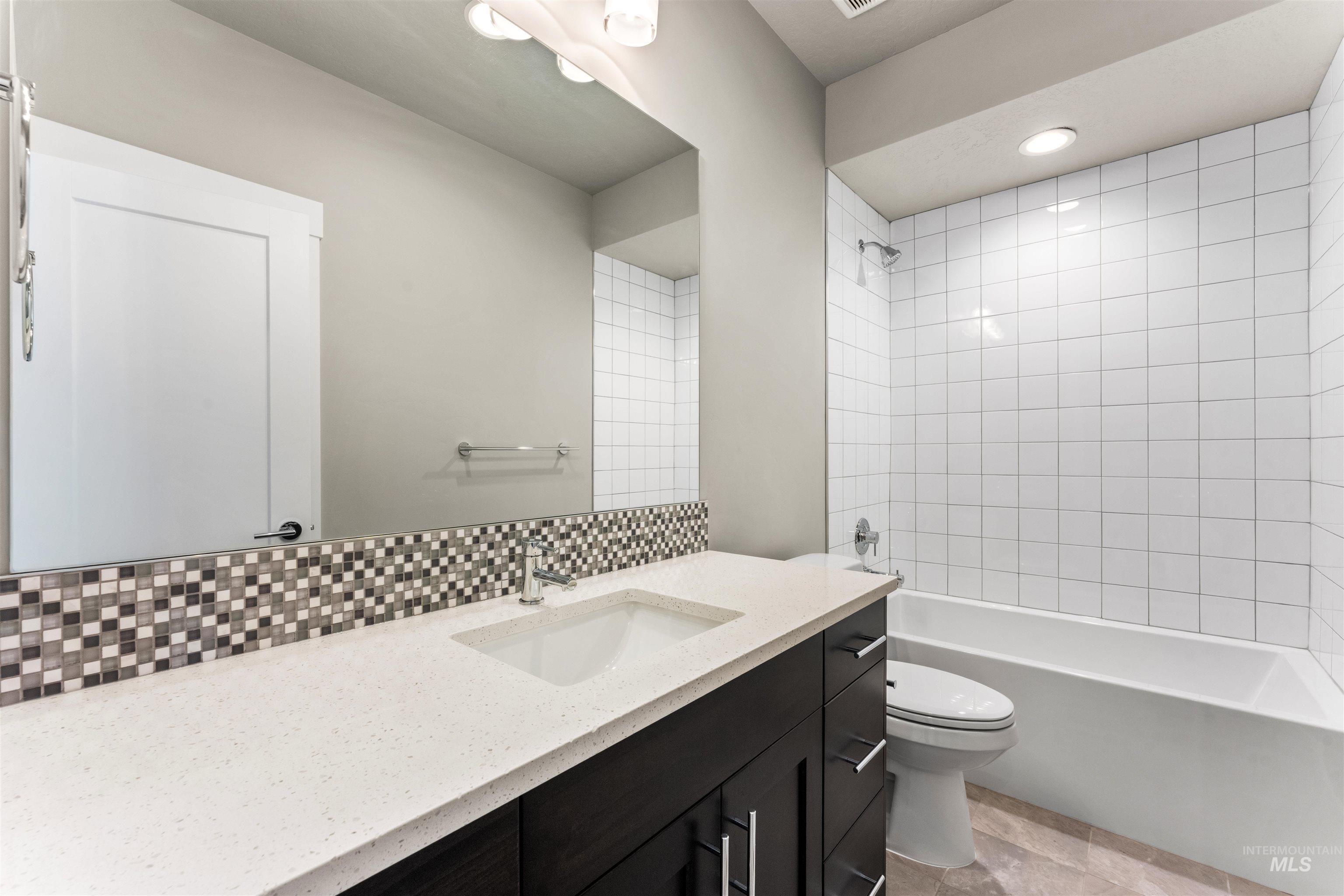 8081 Tandy Cove Street Middleton, ID 83644 - Photo 16 of 41 Full bath featuring vanity, tub / shower combination, decorative backsplash, and recessed lighting