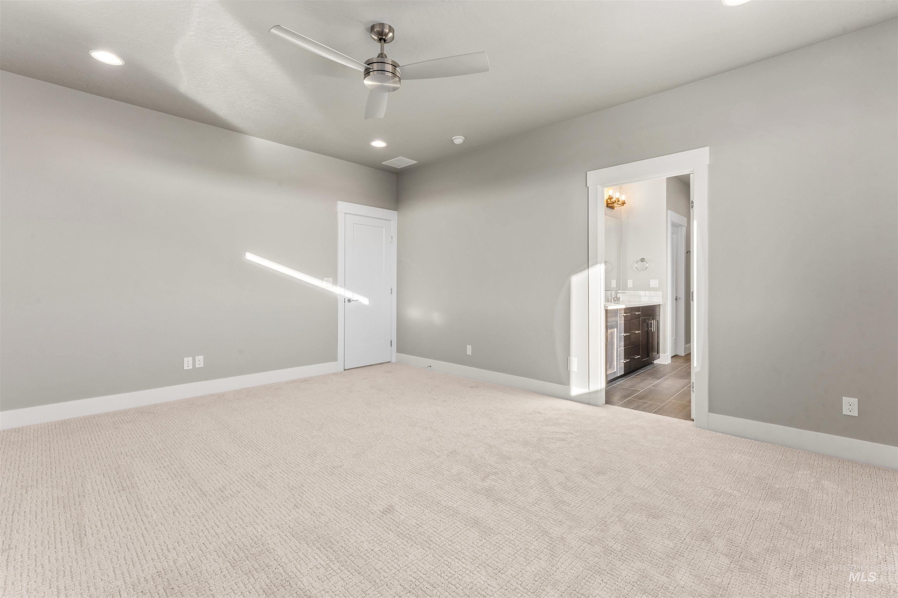 8081 Tandy Cove Street Middleton, ID 83644 - Photo 19 of 41 Unfurnished bedroom featuring light colored carpet, ceiling fan, and recessed lighting