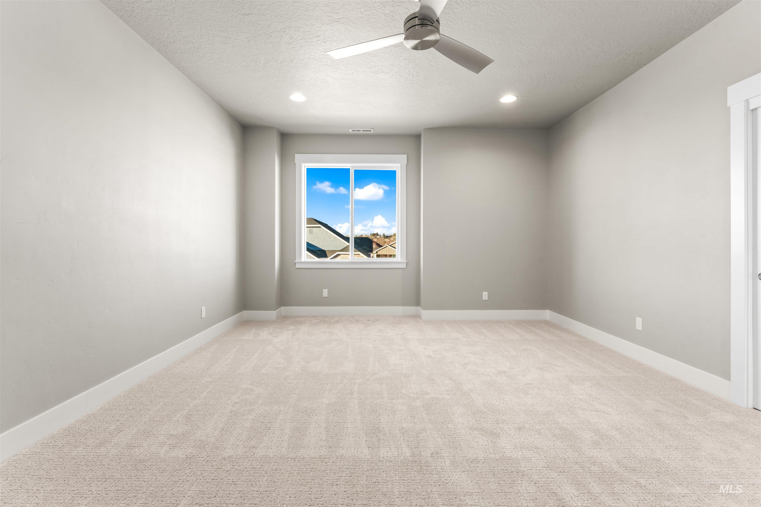 8081 Tandy Cove Street Middleton, ID 83644 - Photo 24 of 41 Unfurnished room with light carpet, ceiling fan, a textured ceiling, and recessed lighting