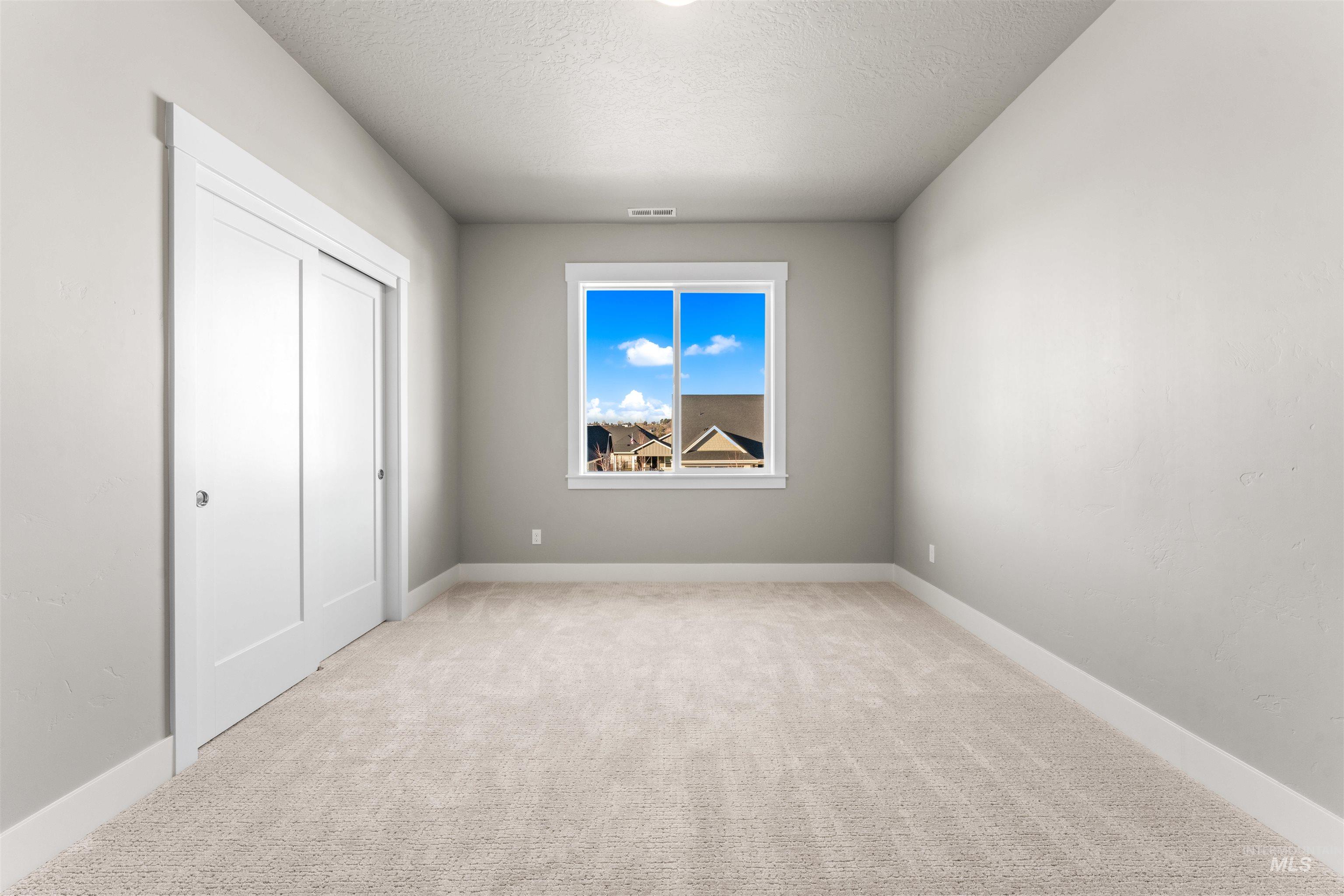 8081 Tandy Cove Street Middleton, ID 83644 - Photo 27 of 41 Unfurnished bedroom with light carpet and a textured ceiling