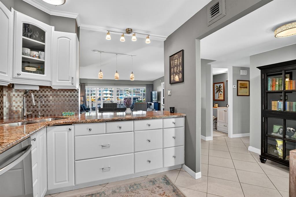 1537 East Hillsboro Boulevard, Unit 138 Deerfield Beach, FL 33441 - Photo 14 of 43 a kitchen with granite countertop a sink and cabinets