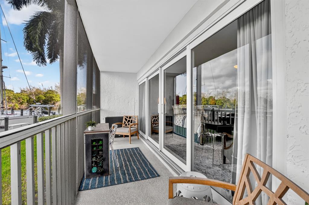 1537 East Hillsboro Boulevard, Unit 138 Deerfield Beach, FL 33441 - Photo 2 of 43 a balcony with wooden floor