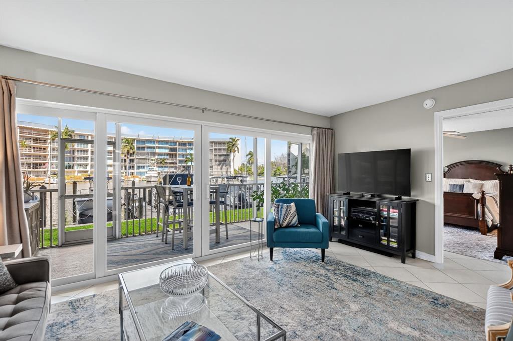 1537 East Hillsboro Boulevard, Unit 138 Deerfield Beach, FL 33441 - Photo 24 of 43 a living room with furniture a flat screen tv and a fireplace