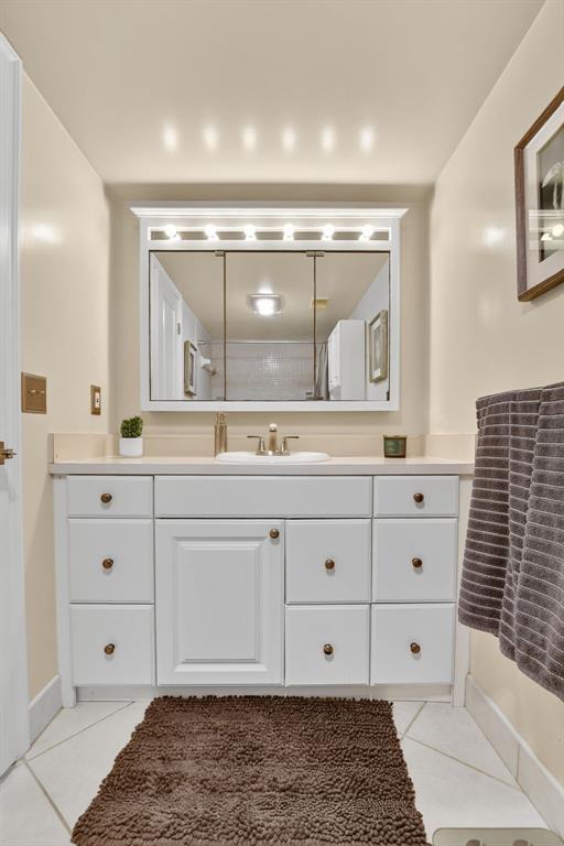 1537 East Hillsboro Boulevard, Unit 138 Deerfield Beach, FL 33441 - Photo 28 of 43 a bathroom with a sink a vanity and a mirror
