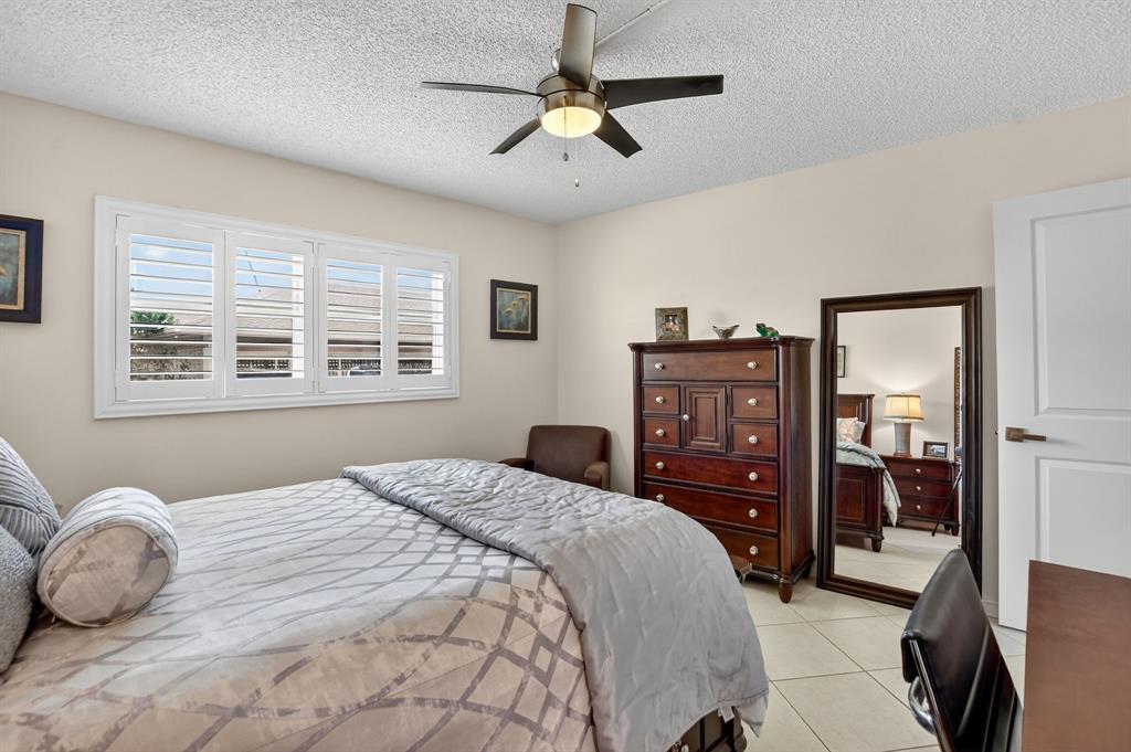1537 East Hillsboro Boulevard, Unit 138 Deerfield Beach, FL 33441 - Photo 33 of 43 a bedroom with a bed and wooden floor