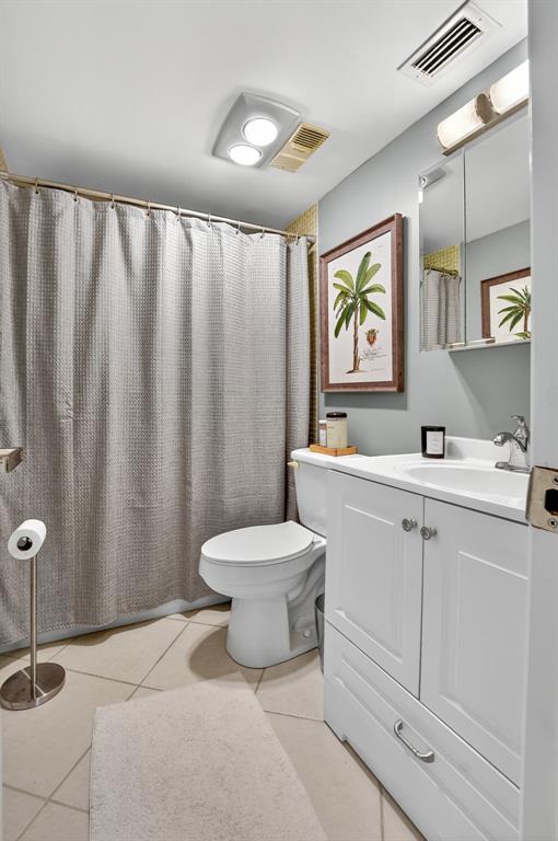 1537 East Hillsboro Boulevard, Unit 138 Deerfield Beach, FL 33441 - Photo 36 of 43 a bathroom with a toilet sink and mirror