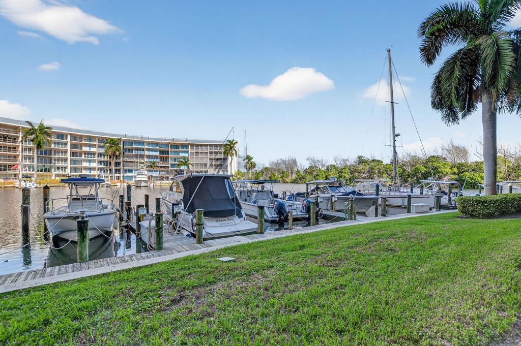 1537 East Hillsboro Boulevard, Unit 138 Deerfield Beach, FL 33441 - Photo 41 of 43 a view of a chairs and table in patio with a yard