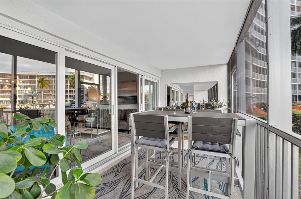 1537 East Hillsboro Boulevard, Unit 138 Deerfield Beach, FL 33441 - Photo 5 of 43 a view of a patio with table and chairs and potted plants