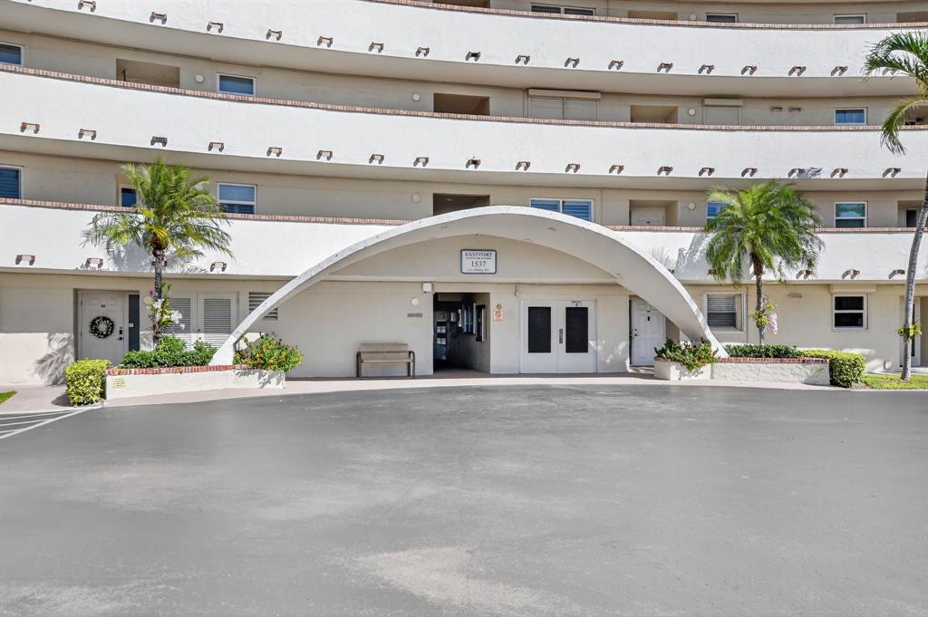 1537 East Hillsboro Boulevard, Unit 138 Deerfield Beach, FL 33441 - Photo 8 of 43 a front view of a building with garden