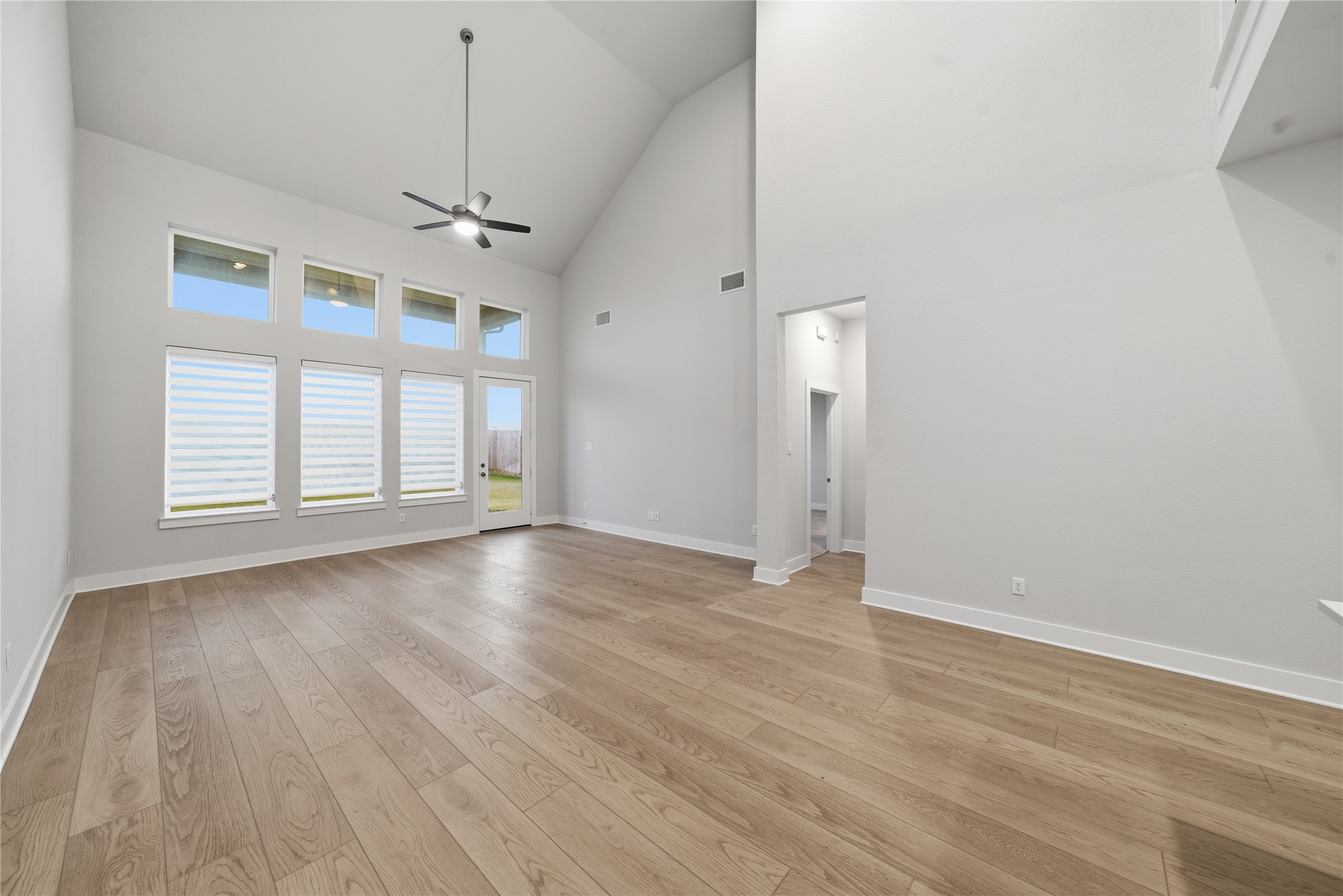 31719 Hatcher Grv Lane Fulshear, TX 77441 - Photo 14 of 40 an empty room with wooden floor exposed radiator and windows