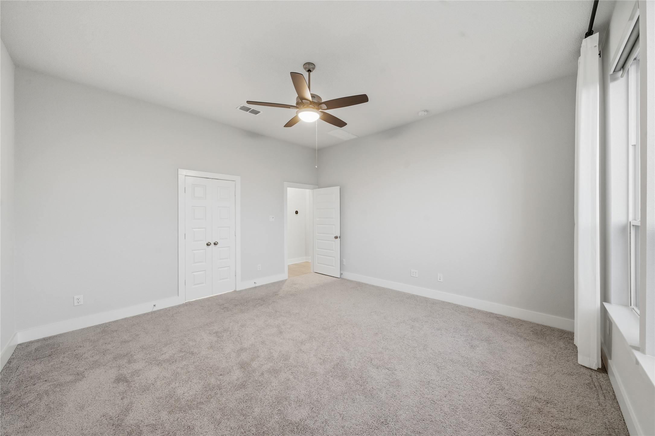 31719 Hatcher Grv Lane Fulshear, TX 77441 - Photo 18 of 40 an empty room with a ceiling fan and a window