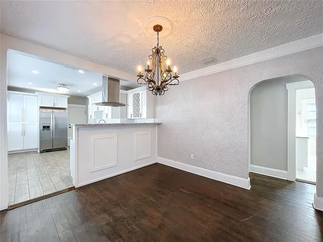 a view of a kitchen with wooden floor and a kitchen