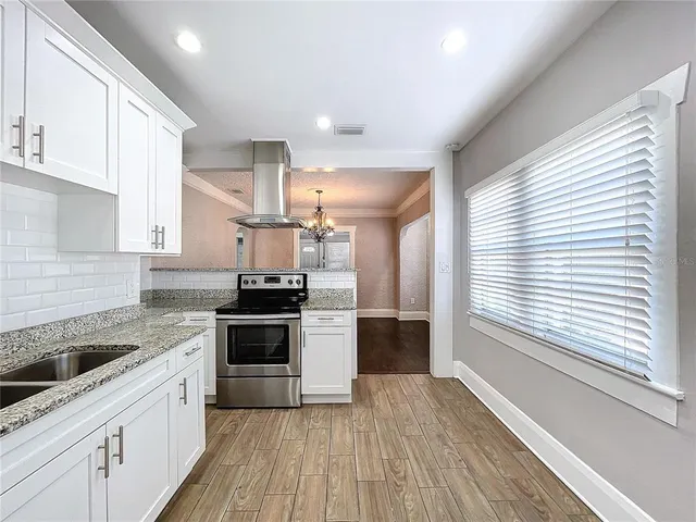 a large kitchen with a stove top oven