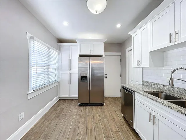 a kitchen with a refrigerator and cabinets