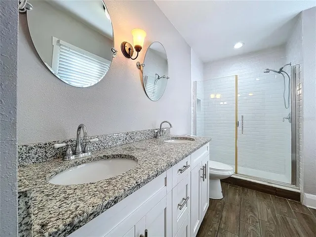 a bathroom with a granite countertop sink mirror and vanity