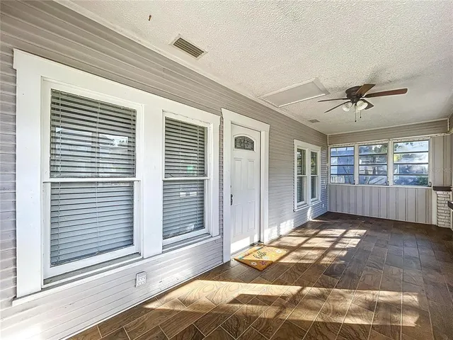 a view of a livingroom with a fireplace and windows