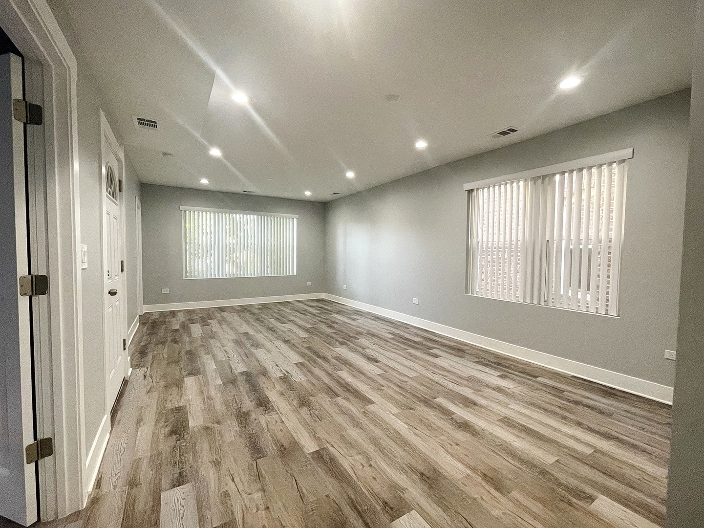 4435 West Thomas Street, Unit 1 Chicago, IL 60651 - Photo 2 of 11 a view of empty room with wooden floor and fan