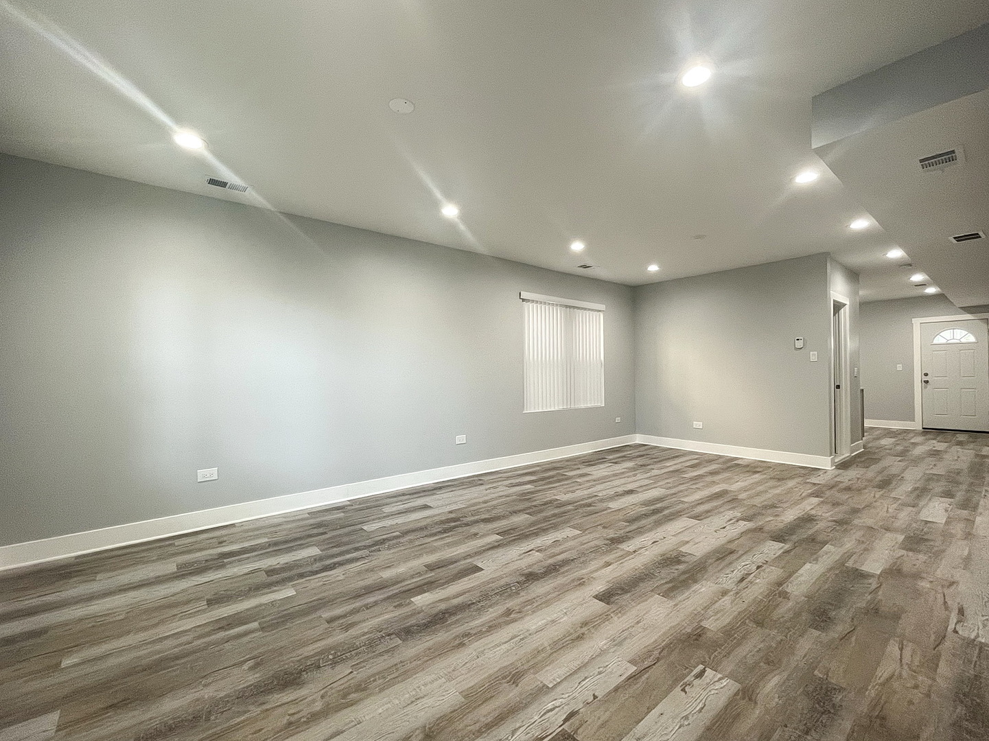 4435 West Thomas Street, Unit 1 Chicago, IL 60651 - Photo 3 of 11 an empty room with window and wooden floor