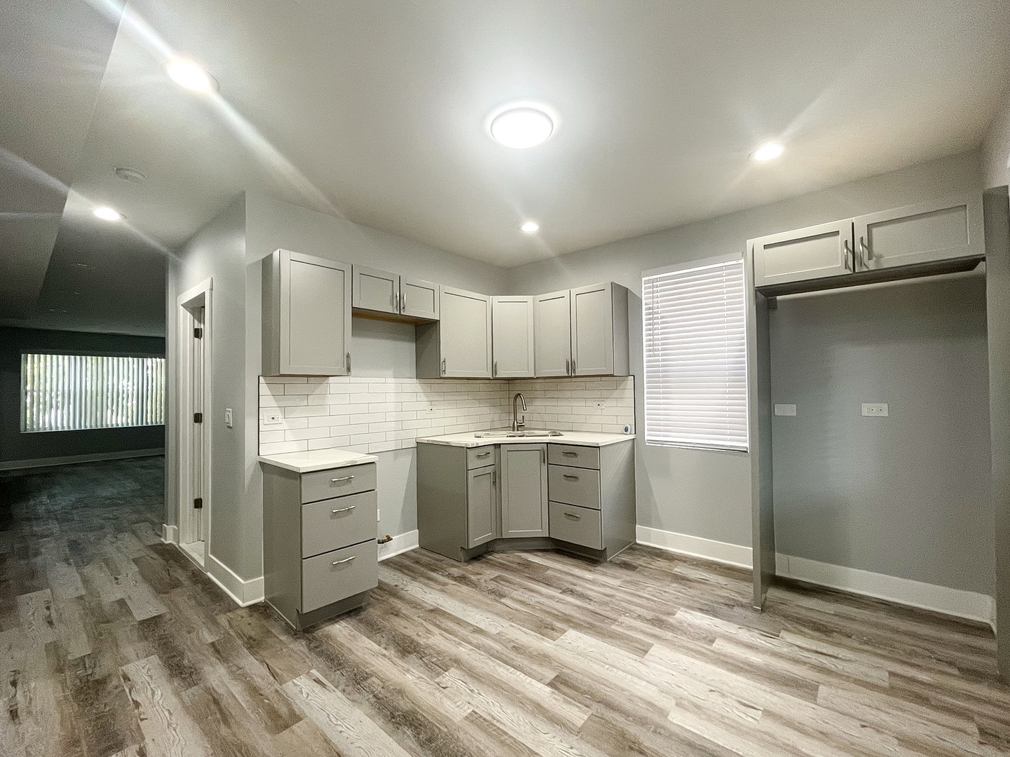 4435 West Thomas Street, Unit 1 Chicago, IL 60651 - Photo 4 of 11 a kitchen with stainless steel appliances granite countertop a refrigerator and a sink