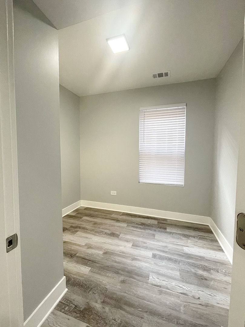 4435 West Thomas Street, Unit 1 Chicago, IL 60651 - Photo 6 of 11 a view of an empty room with a window