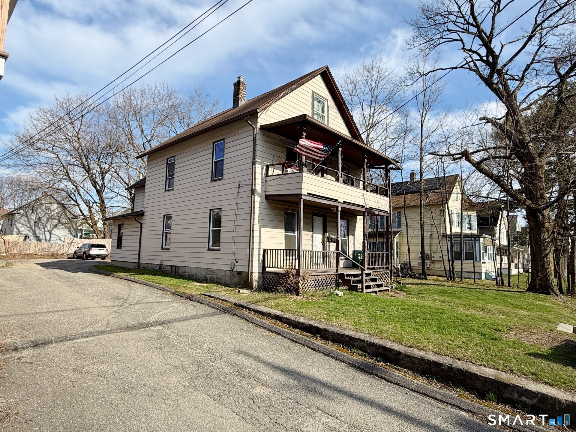 690 Main Street, Unit 1 Torrington, CT 06790 - Photo 1 of 12 a front view of a house with a yard
