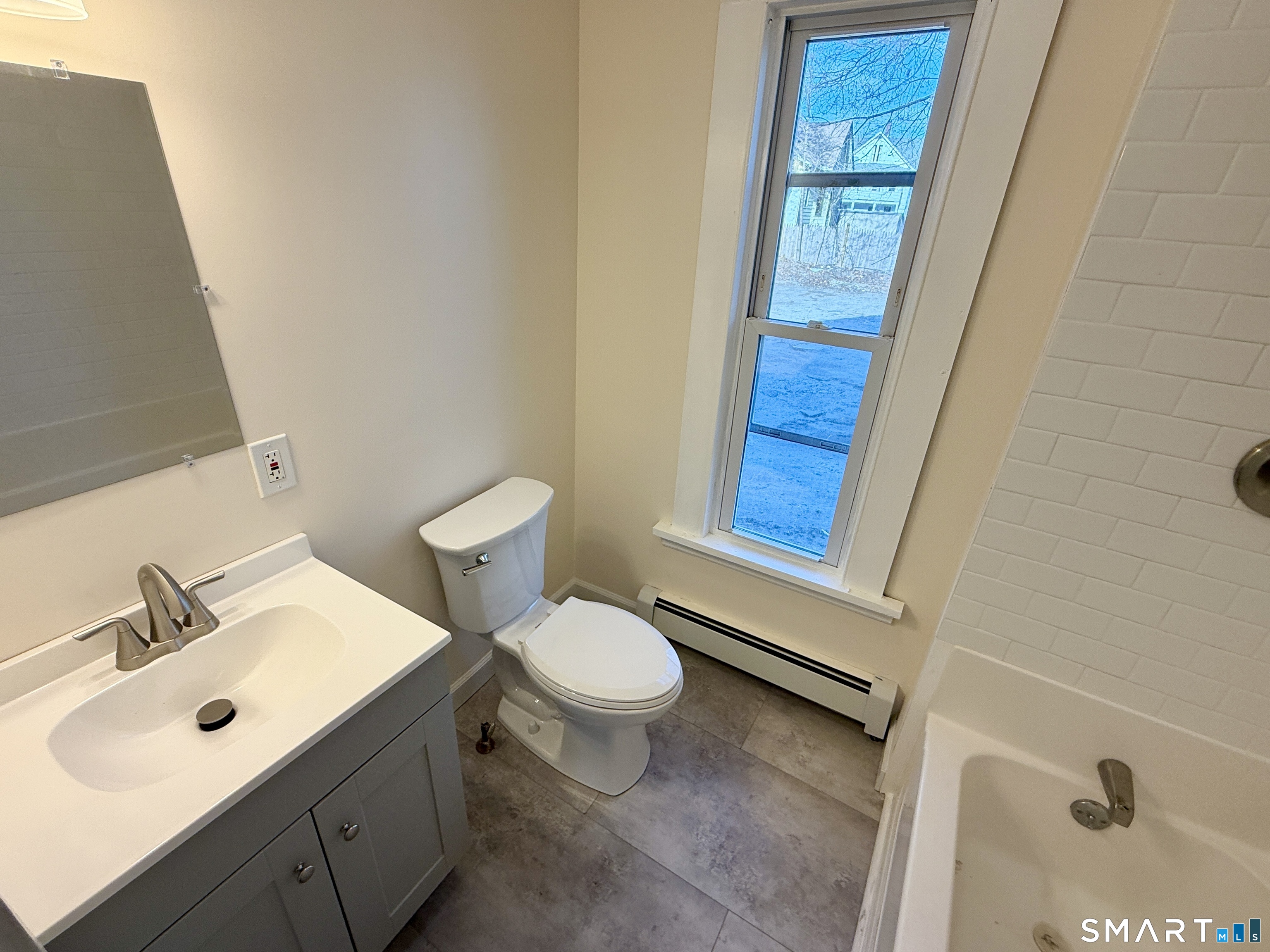 690 Main Street, Unit 1 Torrington, CT 06790 - Photo 11 of 12 a bathroom with a sink a toilet and shower