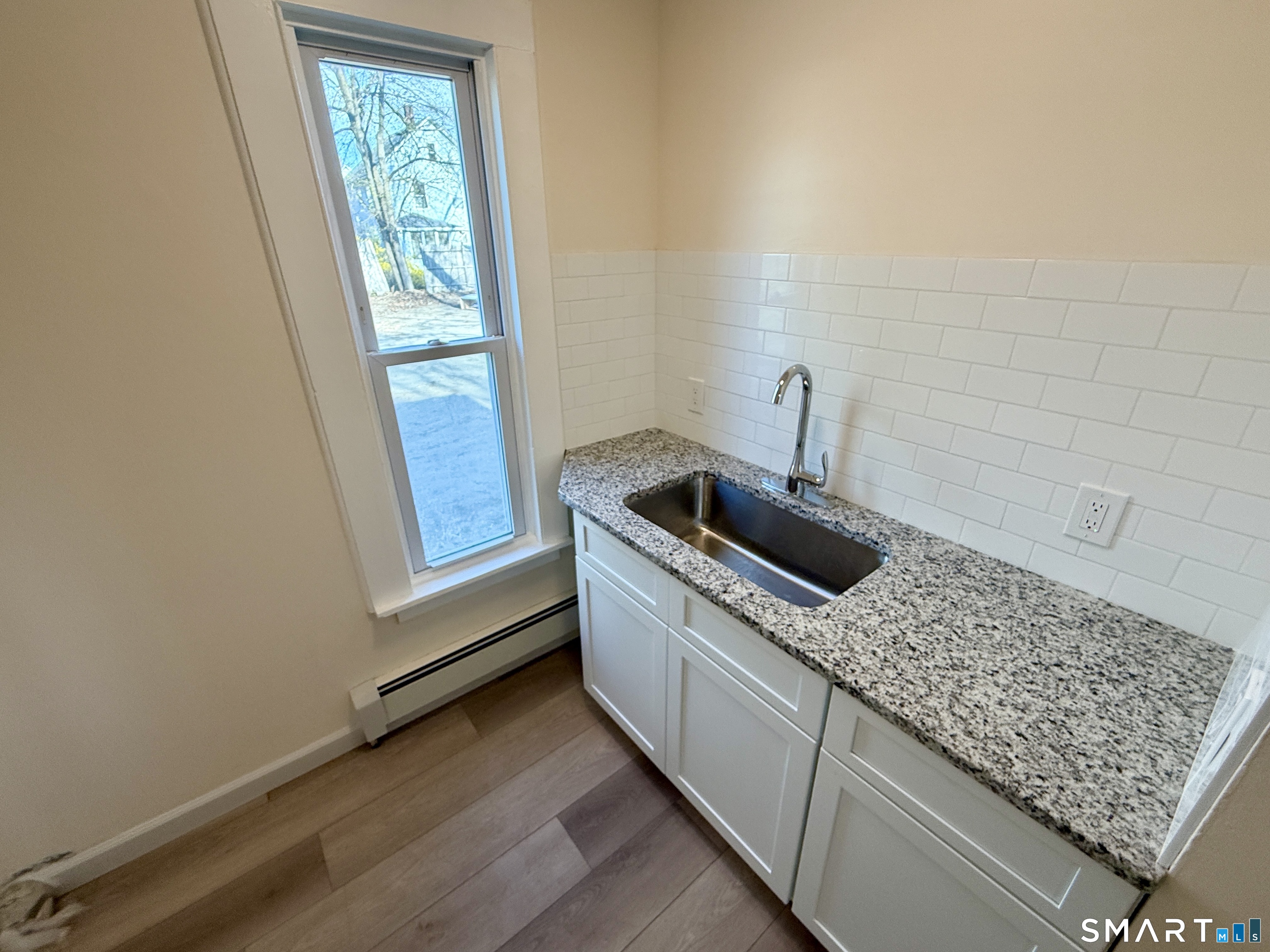 690 Main Street, Unit 1 Torrington, CT 06790 - Photo 4 of 12 a kitchen with sink and window