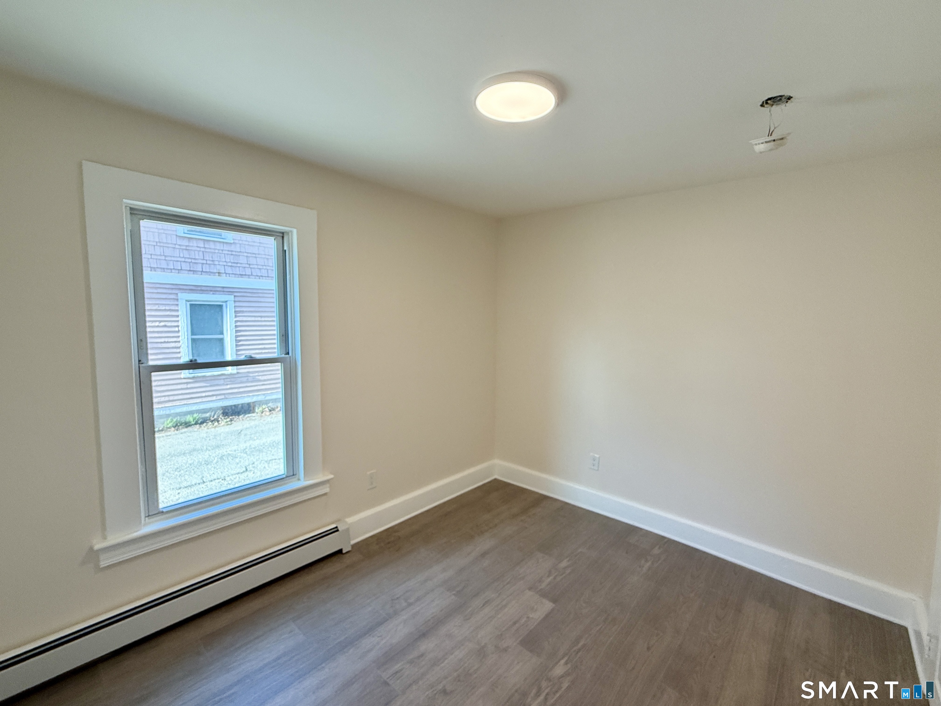 690 Main Street, Unit 1 Torrington, CT 06790 - Photo 8 of 12 an empty room with a window