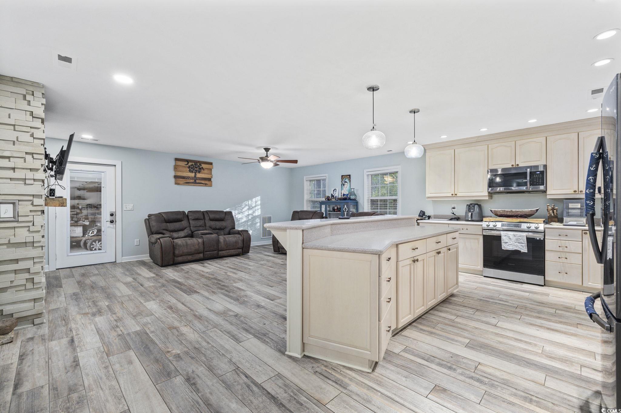 153 Watson Way Pawleys Island, SC 29585 - Photo 40 of 40 Kitchen with appliances with stainless steel finishes, recessed lighting, light countertops, open floor plan, and pendant lighting