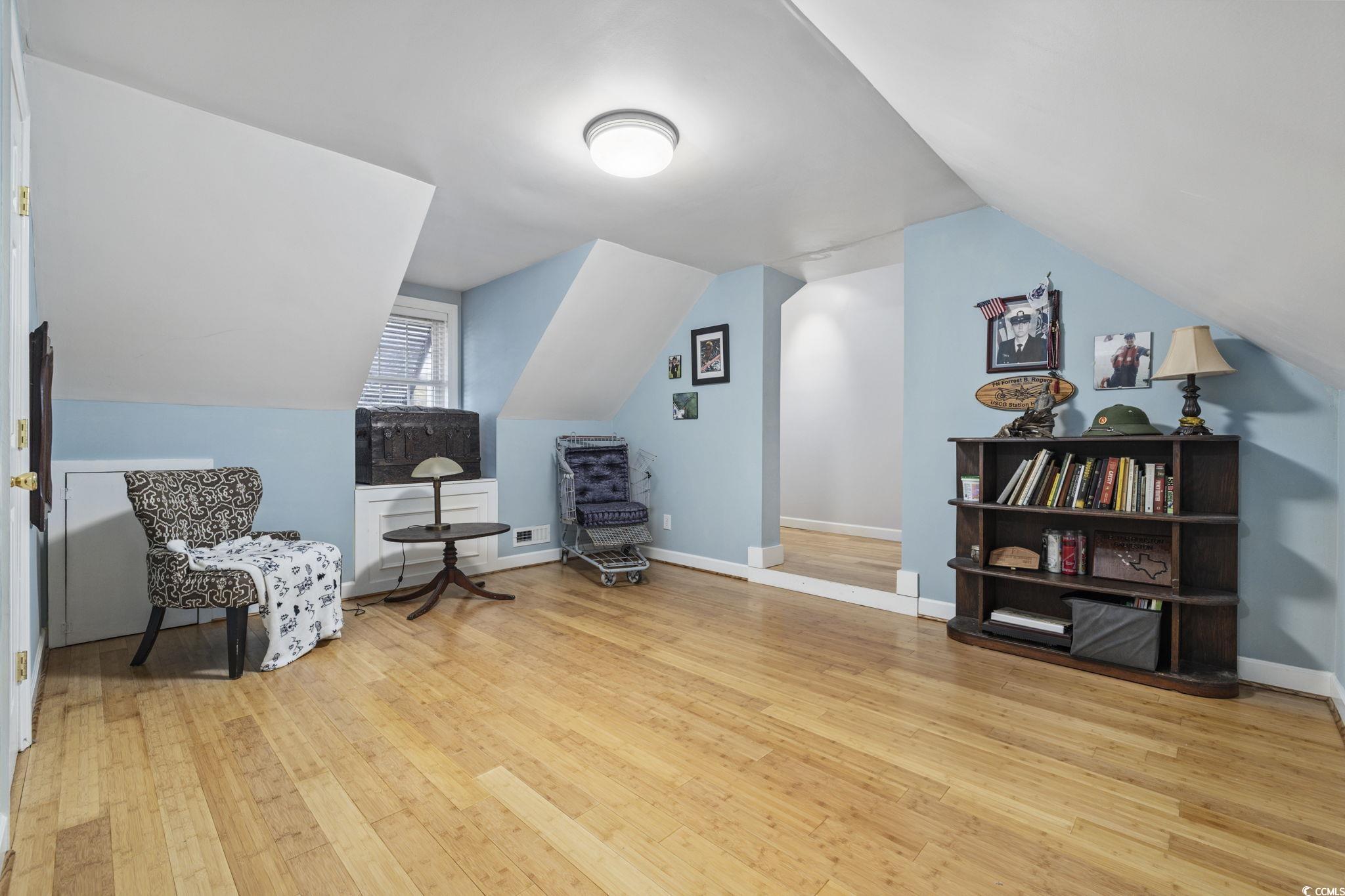 153 Watson Way Pawleys Island, SC 29585 - Photo 12 of 40 Living area featuring light wood-style floors and vaulted ceiling