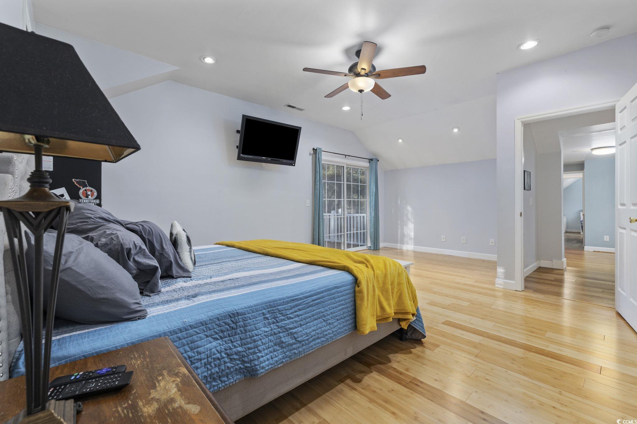 153 Watson Way Pawleys Island, SC 29585 - Photo 14 of 40 Bedroom with recessed lighting, light wood-style floors, lofted ceiling, a ceiling fan, and access to outside