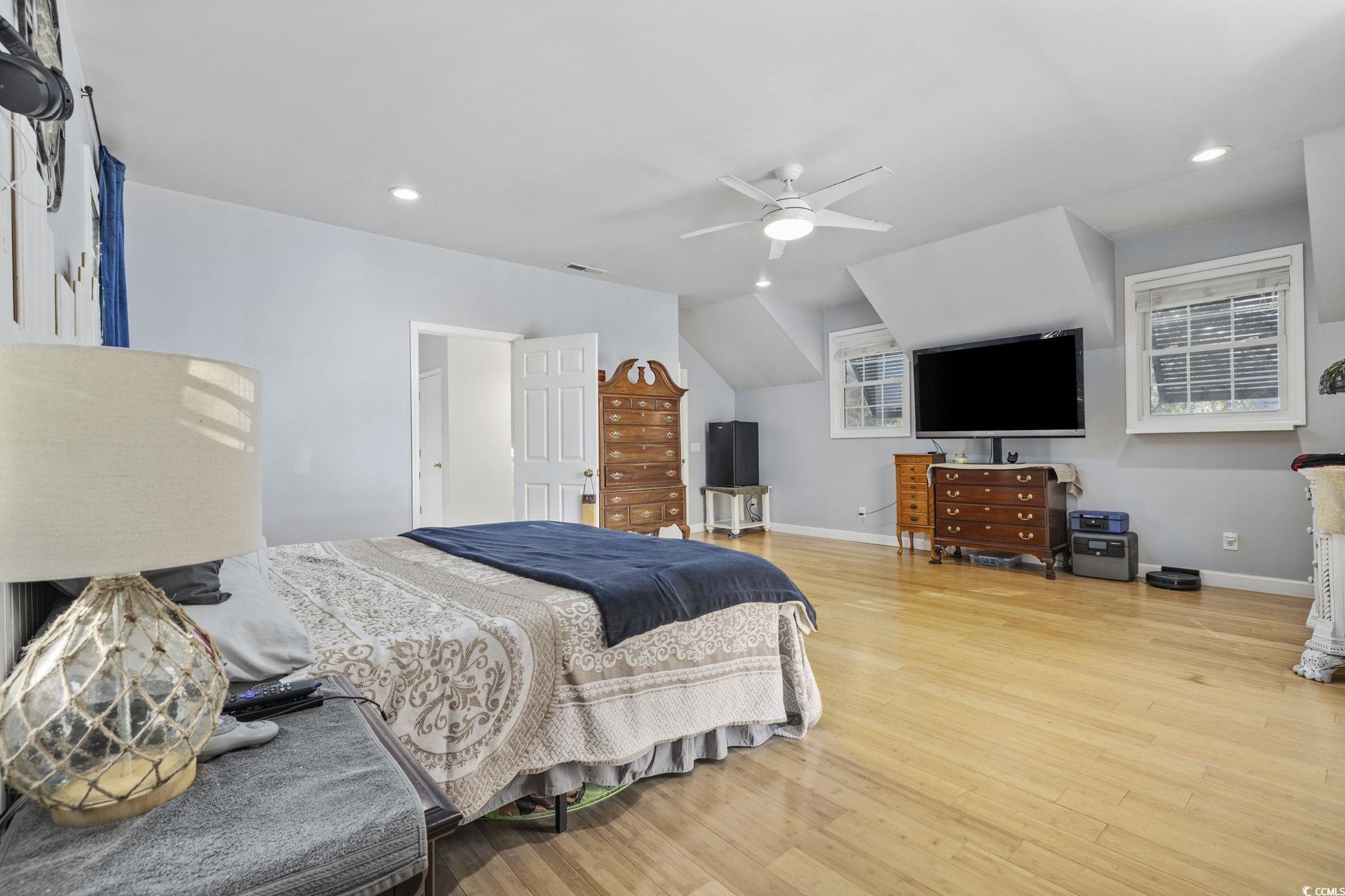 153 Watson Way Pawleys Island, SC 29585 - Photo 15 of 40 Bedroom featuring light wood-type flooring, recessed lighting, ceiling fan, and lofted ceiling