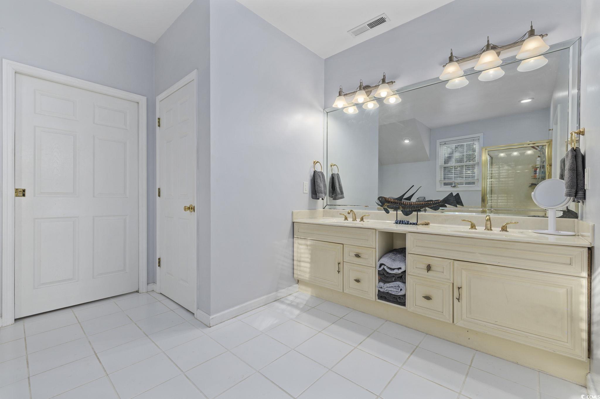 153 Watson Way Pawleys Island, SC 29585 - Photo 16 of 40 Full bathroom with a shower stall, light tile patterned flooring, and double vanity