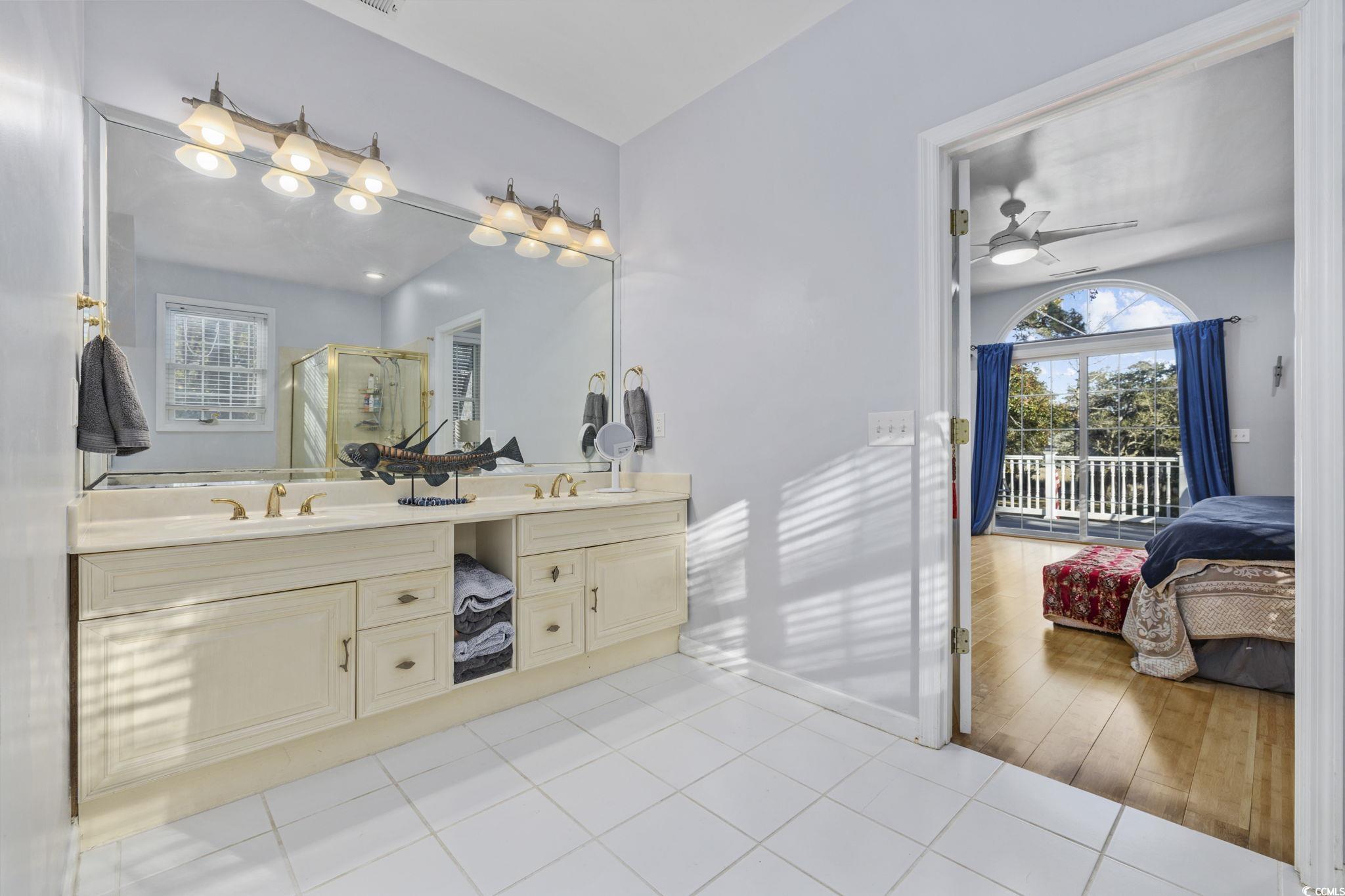 153 Watson Way Pawleys Island, SC 29585 - Photo 18 of 40 Ensuite bathroom with a shower stall, double vanity, light tile patterned floors, and a ceiling fan