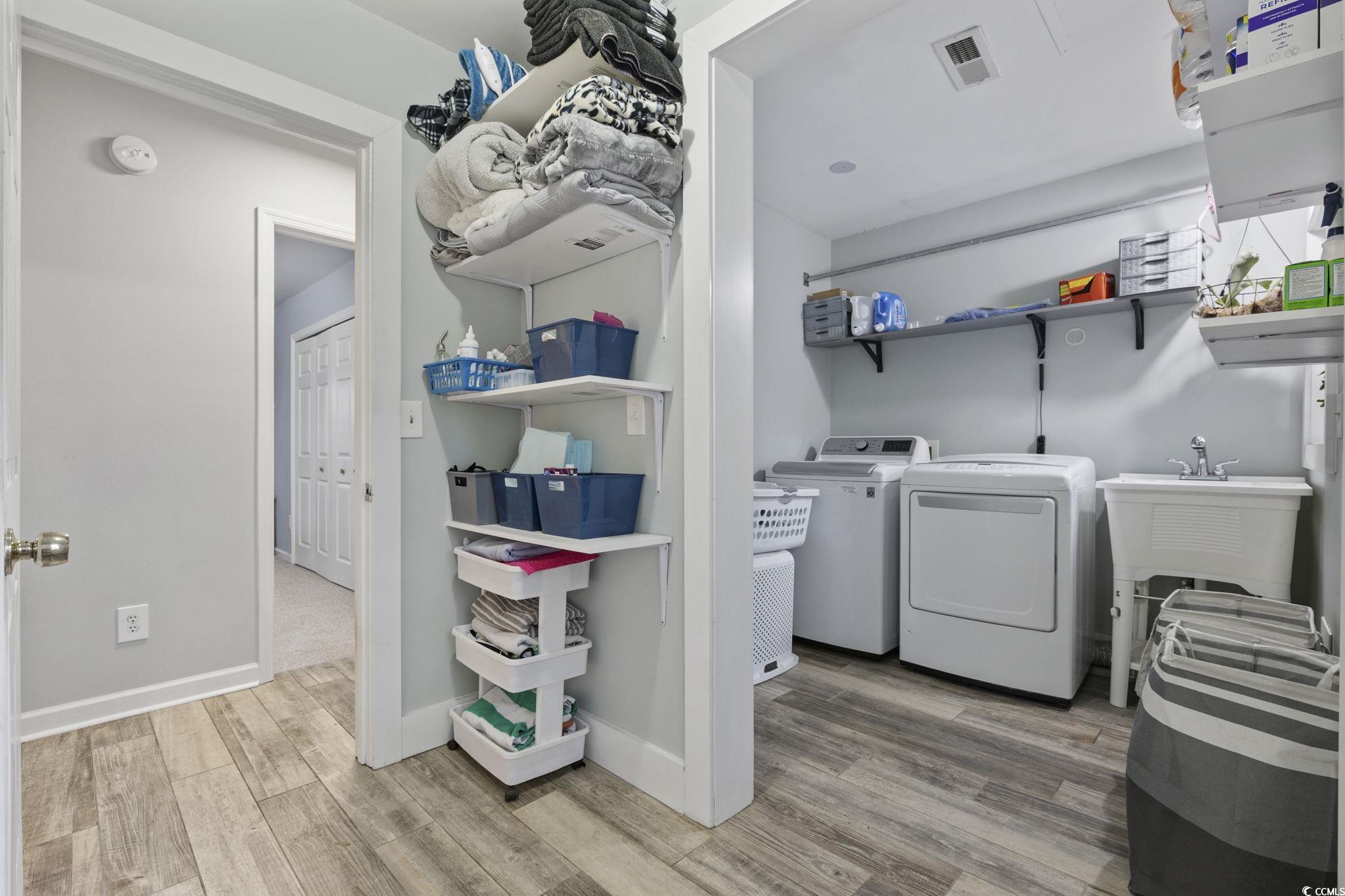 153 Watson Way Pawleys Island, SC 29585 - Photo 26 of 40 Washroom featuring light wood-style flooring, independent washer and dryer, and a heating unit