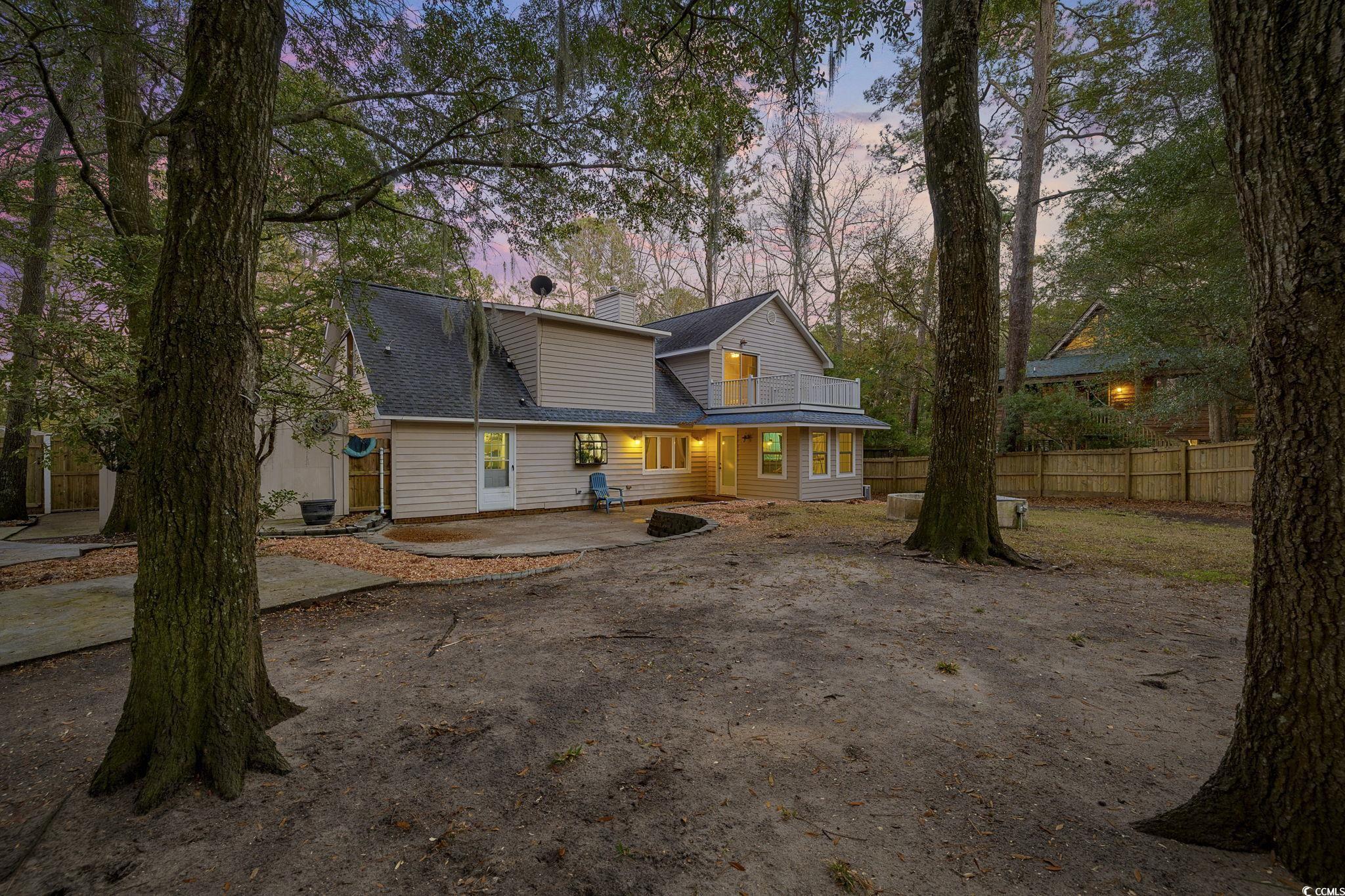 153 Watson Way Pawleys Island, SC 29585 - Photo 28 of 40 View of front of property with a patio, a chimney, and roof with shingles