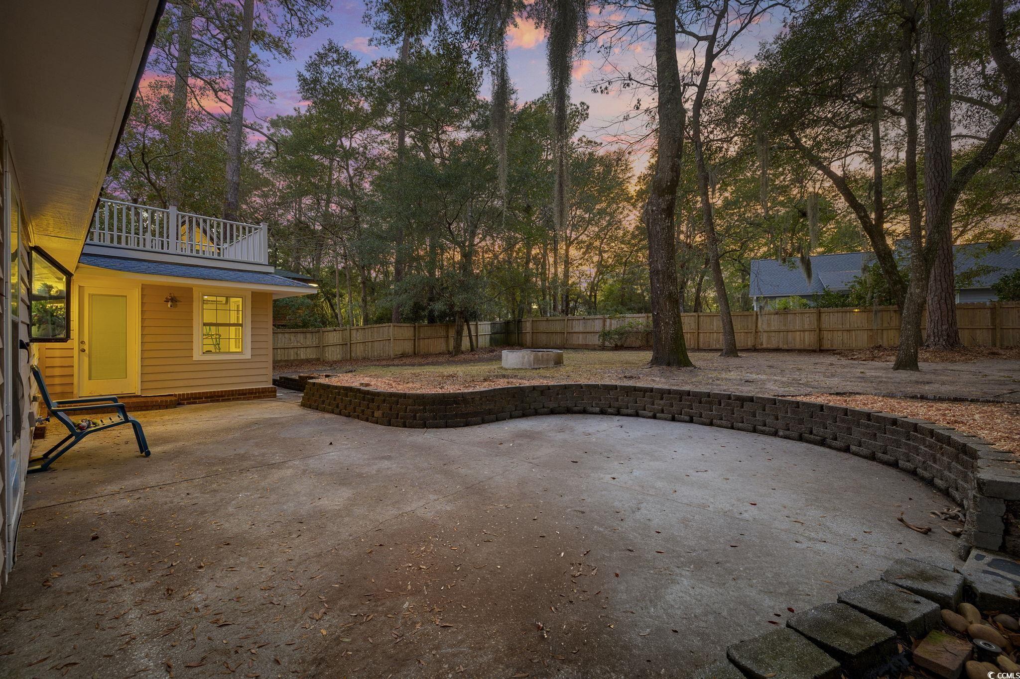 153 Watson Way Pawleys Island, SC 29585 - Photo 33 of 40 Patio terrace at dusk with a patio and a fenced backyard