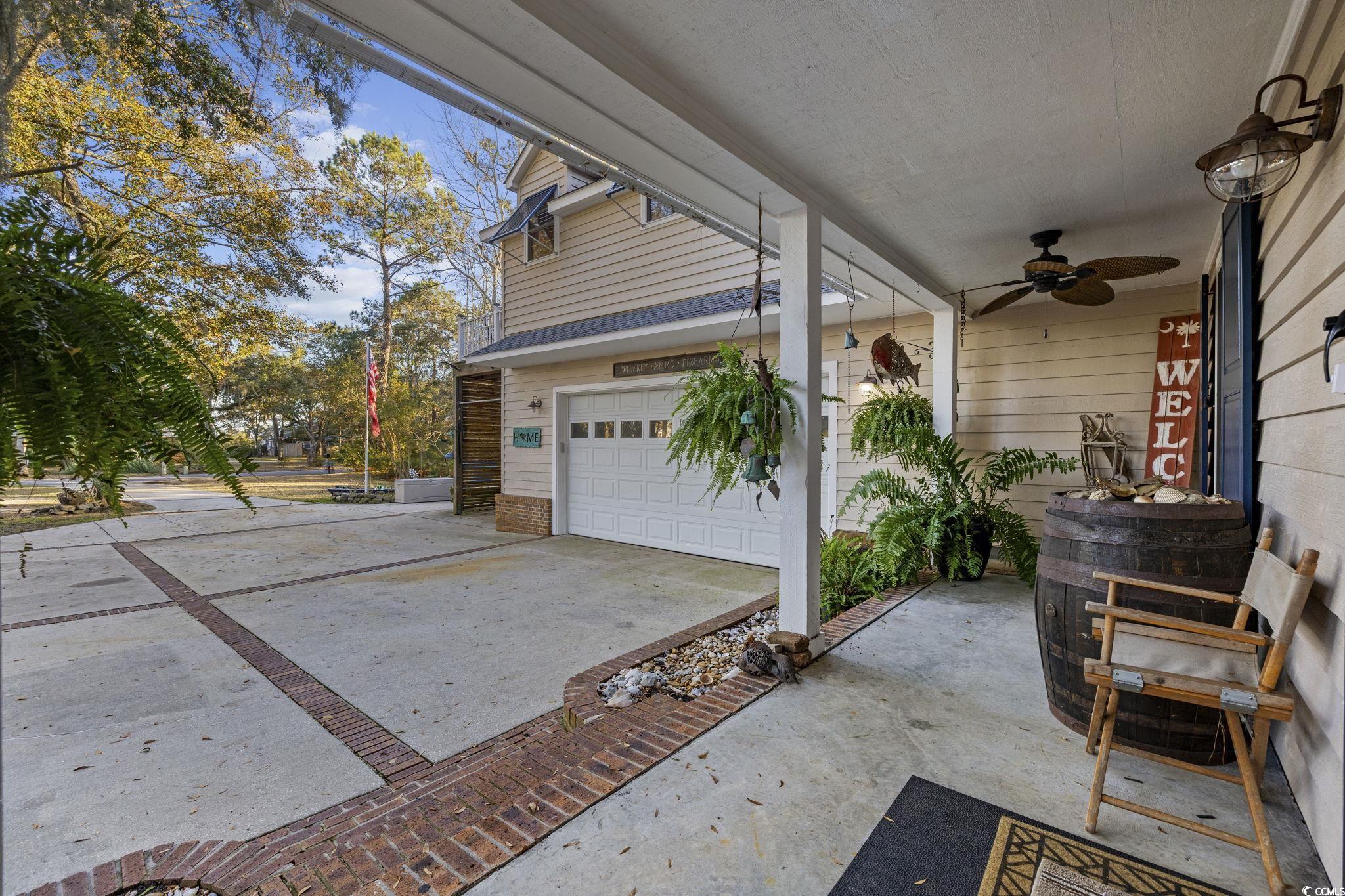 153 Watson Way Pawleys Island, SC 29585 - Photo 4 of 40 Garage featuring concrete driveway and ceiling fan